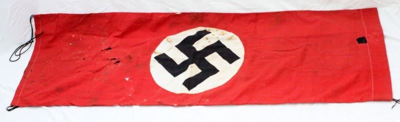 WWII THIRD REICH HAND MADE VINTAGE BANNER: NSDAP Third Reich hand made banner. The front depicts the party flag, the reverse has a black center with white side stripes. Appears heavily used. Some moth holes and tears. 17 inches wide by 50 inch