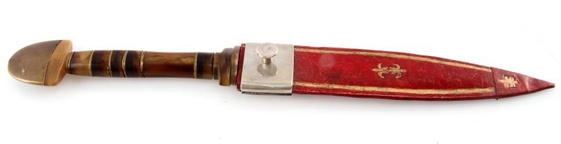 AFRICAN LEAF BLADE KNIFE WITH HORN AND BRASS GRIP: The knife has a five-inch, leaf-shaped blade and a horn and brass handle with a large, brass pommel. The blade is in good condition with some wear from use. Includes a red and gold sheath that is in g