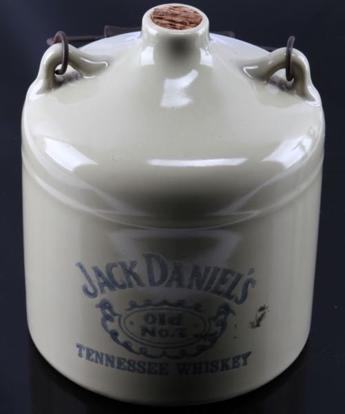 JACK DANIELS OLD NUMBER 7 WHISKEY HANDLED JUG: Wood and metal handle with cork, stands eight inches.
