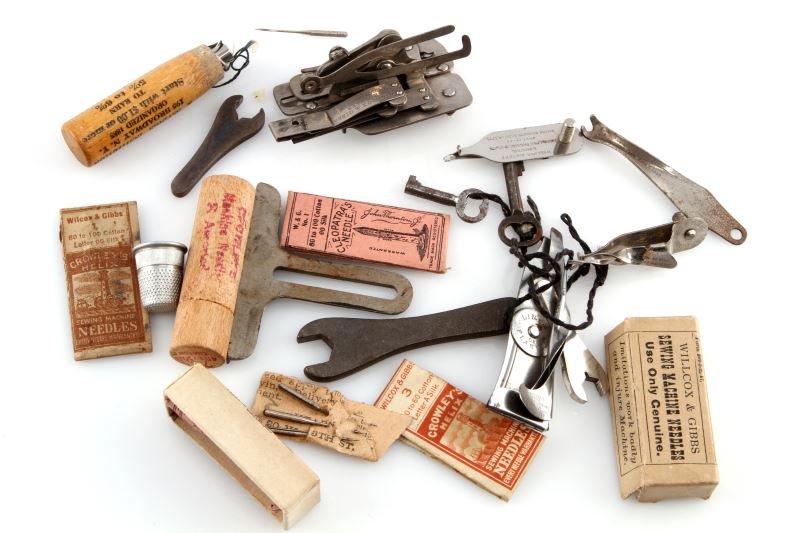 LOT OF CIVIL WAR SEWING MACHINE NEEDLES & TOOLS: Patent dates as early as 1864, keys, tools, original wrapped and or boxed sewing machine needles, tools and parts.