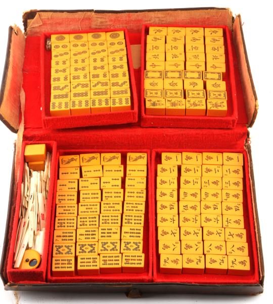 BAKELITE & BONE ANTIQUE MAHJONG SET: Complete with 144 tiles, rules book with Shanghai duty stamp, has counter, case is roughed up but is leather, set appears to be 1930's or 1940's.