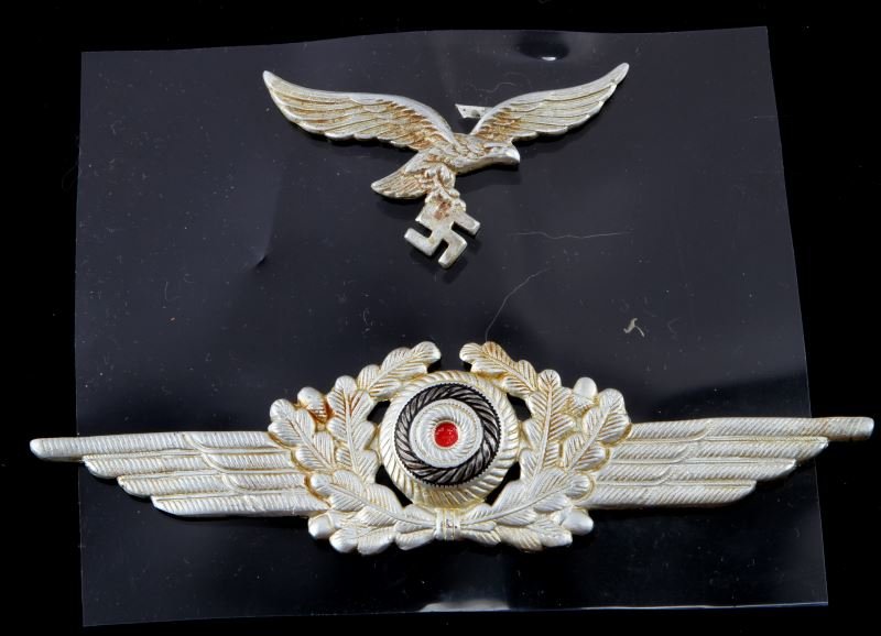 2 GERMAN WWII BADGES FOR LUFTWAFFE PILOT HAT: Light wear and fading present to badges; overall in very good condition. Unauthenticated as is.