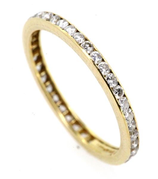 LADIES 18KT YG TIFFANY & CO DIAMOND ETERNITY BAND: Although ring is missing one diamond, this 18kt yellow gold eternity band created by Tiffany & Co. is still a stunner, containing 38 round brilliant cut diamonds, each weighing approximately .02cts, f