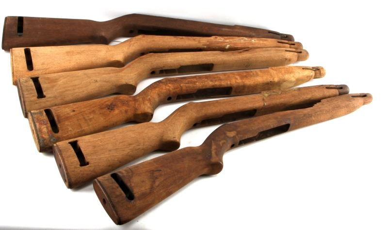 LOT OF 6 M1 CARBINE WOOD RIFLE STOCKS UNFINISHED: Six wooden M1 and M1 Carbine rifle stocks. Light and dark wood, all have sling slot, unfinished wood. Two have slight loss to top right side, two have glue residue. Overall good to very good condition