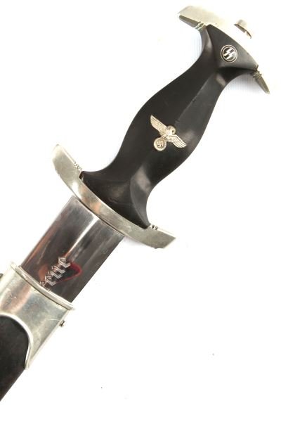 1933 THIRD REICH SPORTSCHULE FURTH SS DAGGER: Excellent engraved Wagner stamped blade, SS roundel has slight enamel loss, wood grip is very good, scabbard paint has faded. This lot has a reserve.