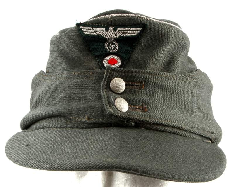 WWII THIRD REICH GERMAN HEER ARMY M43 FIELD CAP: WWII Third Reich German Army M43 field cap. Silver bullion piping, pebble buttons, and bulls eye patch. Stamped (58) to interior. One moth hole to visor. Very good condition.