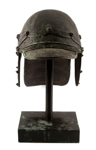 BRONZE ZISCHAGGE LOBSTERTAIL HELMET N. EUROPEAN: A Northern European zischagge or lobstertail helmet made in cast bronze and mounted onto a black marble base. Made with ornate detail. In very good condition.
