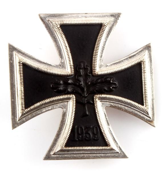 WWI GERMAN THIRD REICH IRON CROSS 1ST CLASS: An Iron Cross first class medal. Variation with central oak leaves and date. Fitted with a wiper pin with "C"clasp and with 180 degree pin lie. Measures 45 mm in diameter.