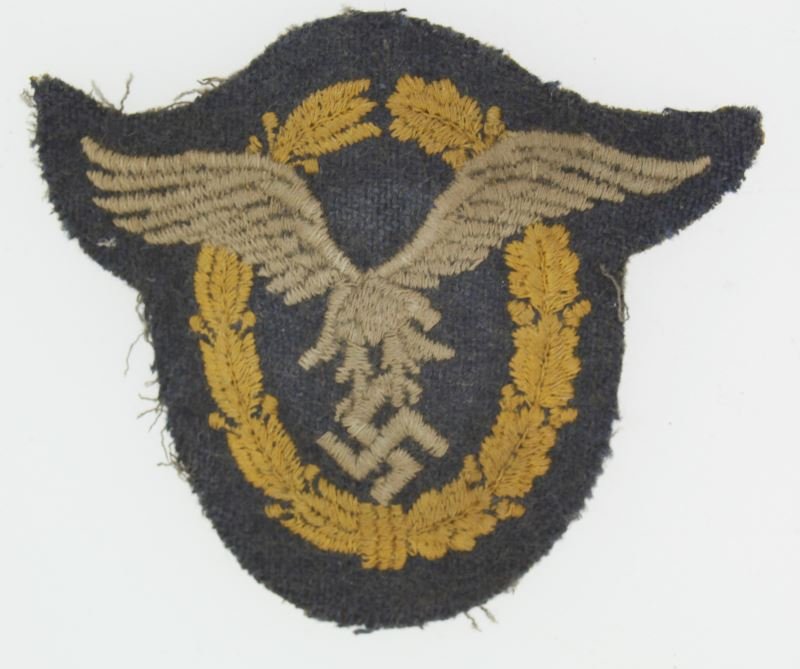 WWII THIRD REICHLUFTWAFFE PILOT OBSERVER PATCH: A patch version of the Luftwaffe's pilot observer badge. Padded construction with embroidered thread. In very good condition. Rear marked with the number six within a circle.