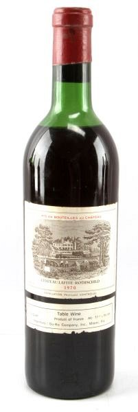1970 CHATEAU LAFITE-ROTHSCHILD FULL BOTTLE WINE: Vintage 1970 Chateau Lafite-Rothschild red Bordeaux blend. Label and seal still present. Top shoulder ullage. Cherry red color. The label has some foxing and tears, but overall good condition. Tight w