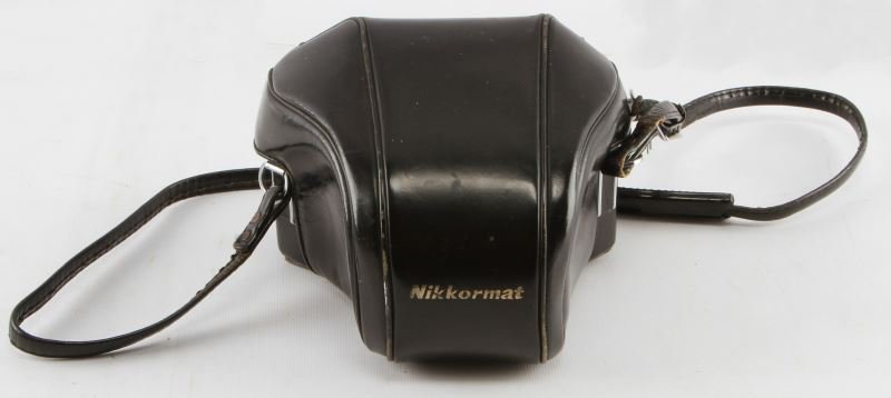 NIKON NIKKORMAT 35MM SLR WITH NIKKOR 50MM F/2 LENS: Silver finish Nikkormat 35mm SLR with Nikkor-H 50mm f/2 lens. Includes black leather case. The camera and the lens are in very good condition and both work as should mechanically although the camera's