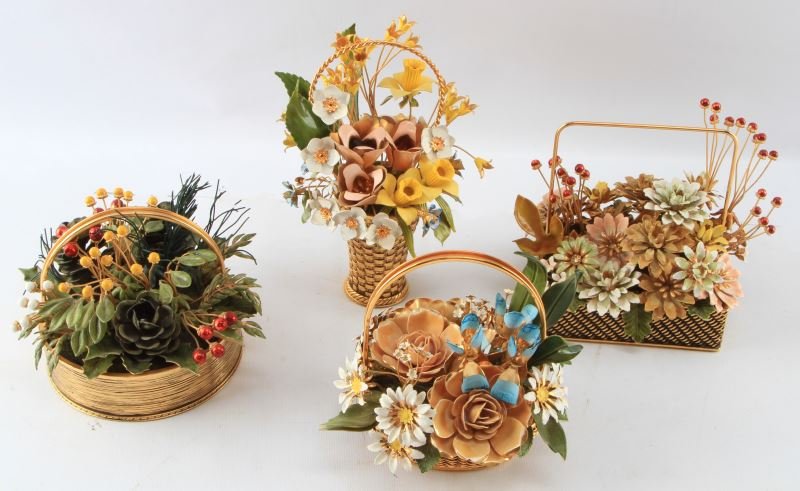 VINTAGE ENAMEL FLOWER BASKETS GLORIA VANDERBILT: Four seasons of enamel flower baskets by Gloria Vanderbilt. Each bouquet has a label on the base naming the bouquet and attributing it to Gloria Vanderbilt. Copyright 1977. Items are in very good cond