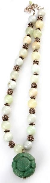 LADIES VINTAGE JADE NECKLACE WITH STERLING BEADS: 24 inches long, sterling decorative findings, with 24 light green jadeite beads, each approximately 14mm in diameter. At bottom, large carved fetish piece, 33 x 19.5mm. In very good condition.