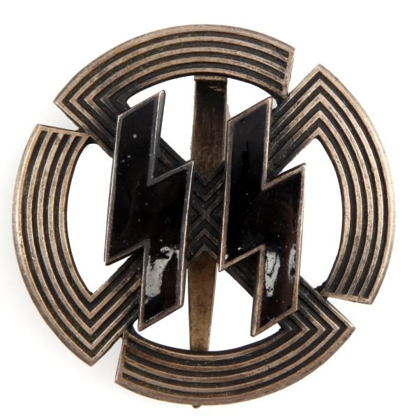 THIRD REICH SS SPORTS PROFICIENCY BADGE IN SILVER: An SS Sports Proficiency badge in silver. Features a pair of black enameled runes with silver plated edges attached with four flattened pins to a convex mobile swastika. The rear is unmarked, and has 