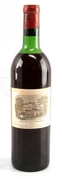 1970 CHATEAU LAFITE ROTHSCHILD RED WINE BORDEAUX: Vintage 1970 Chateau Lafite-Rothschild red Bordeaux blend. Label and seal still present. Top shoulder ullage. Cherry red color. The label has some foxing, but overall good condition. Tight sealed cork