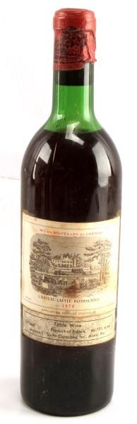 1970 BORDEAUX CHATEAU LAFITE ROTHSCHILD VINTAGE: Vintage 1970 Chateau Lafite-Rothschild red Bordeaux blend. Label and seal still present. Top shoulder ullage. Cherry red color. The label has some foxing, but overall good condition. Tight sealed cork