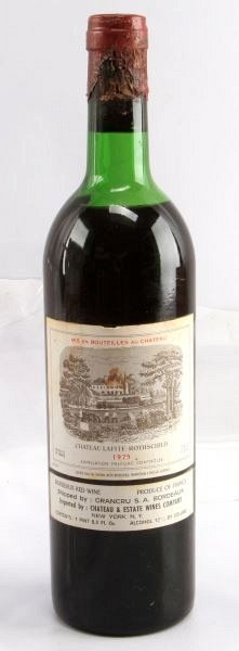 1975 VINTAGE CHATEAU LAFITE ROTHSCHILD BORDEAUX: Vintage 1975 Chateau Lafite-Rothschild red Bordeaux blend. Label and seal still present. Top shoulder ullage. Cherry red color. The label has some discoloration and tears, but overall very good condit