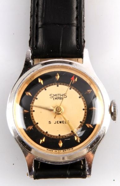 MENS VINTAGE SMITHS EMPIRE JEWELED MVMNT WATCH: Nickel plated 33mm case, jeweled movement by Smiths of Great Britain, Empire series, stem wind and set. Ivory, black and gold color dial in good condition, with "Red Arrow" sweep second hand. Includes