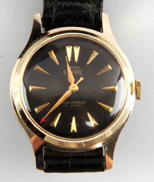 MENS VINTAGE SMITHS EMPIRE JEWELED MVMNT WATCH: Made by Smiths of Great Britain, Empire series, 33mm gold plated case, stem wind and set jeweled movement, watch runs. Black textured dial with gold color markers in good condition, includes "Red Arro