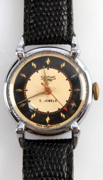 MENS VINTAGE SMITHS EMPIRE JEWELED MVMNT WATCH: Made by Smiths of Great Britain, Empire series, 33mm nickel plated case with fancy lugs, stem wind and set jeweled movement, watch runs. Black dial with ivory center, gold color markers in good/fair c