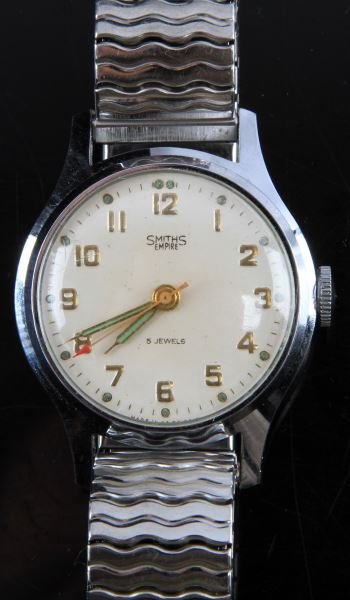 MENS VINTAGE SMITHS EMPIRE JEWELED MVMNT WATCH: Made by Smiths of Great Britain, Empire series, 33mm nickel plated case, stem wind and set jeweled movement, watch runs. White dial with gold color markers in good condition, includes "Red Arrow" swee