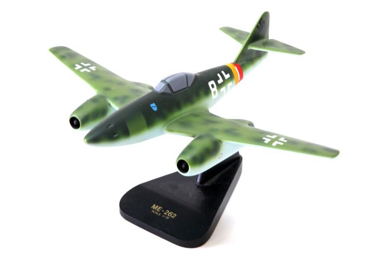 WWII GERMAN ME-262 JET 1/32 SCALE WOOD DESK MODEL: Handmade in the Philippines. 15.5 inch wingspan and 13 inches tip to tail. In good condition with minor paint cracks where engines attach to wings. On black wooden stand.