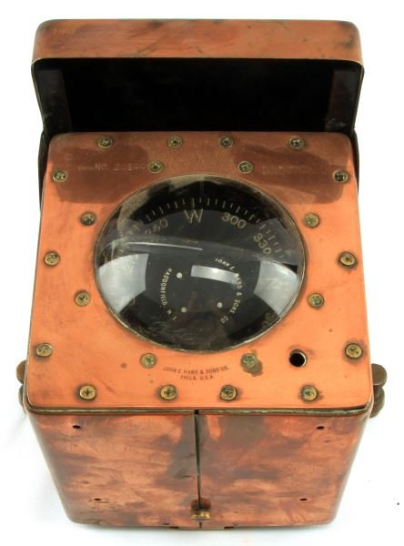 JOHN E. HAND & SONS LIFEBOAT COMPASS LMC-101 D: U.S. Coast Guard Approved S/N 24144, all copper encased with mounts, compass is fully functional, measures six by seven inches.