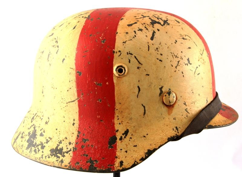 GERMAN WWII ARMY MEDIC M-40 COMBAT HELMET: German WWII Army Medic M-40 Combat helmet. Includes leather liner and chin strap. White painted helmet with painted red cross on top. Stamped on inside of helmet "64TSR" and "ET64". Painted on inside 