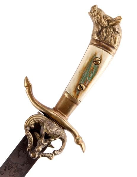 GERMAN HUNTSMANS STAG HORN DAGGER WITH SHEATH: German huntsman's dagger with stag horn grip. Blade is etched with stylized vegetation and zoomorphic figures. Clamshell guard with stag head motif. Stag hoof crossguard. Boar's head pommel. Includes 