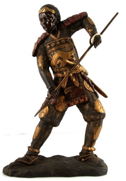 MEIJI PERIOD JAPANESE POLYCHROME BRONZE WARRIOR: Japanese Polychrome Bronze Warrior, Meiji period. Applied red and gold paint, intricate carved details, and glossy finish to face. Stands 17 inches tall and base measures 10 inches long. Weighs 14.4 p