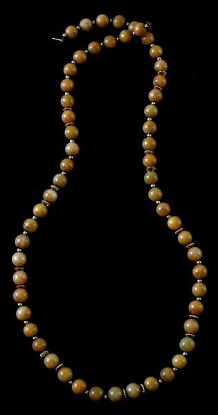 LADIES 28 INCH STRAND YELLOW JADE & 14KT YG BEADS: 28 inches long, ladies strand of 9.5mm yellow jadeite beads, accented by 14kt yellow gold round beads and fluted roundels, 14kt yellow gold pearl clasp. In very good condition (should be re-strung).