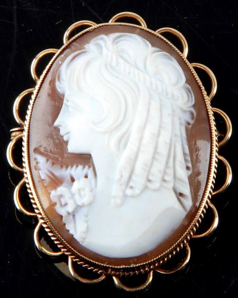LADIES 9KT YELLOW GOLD SHELL CAMEO BROOCH BRITISH: Large piece; 47mm tall, 37mm wide, Birmingham 9kt marked frame with coin edging and wire scallops. Fancy shell cameo, showing left side of face (a bit more rare), in very good condition.
