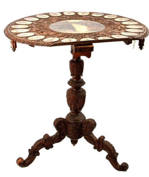 19TH CENTURY TILT TOP TRIPOD PAINTED CARVED TABLE: Antique, 19th century, round, tilt-top tripod table with carved and painted decorations. The center is painted with a landscape, and the surrounding roundels depict women in traditional European dress