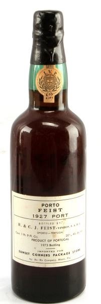 1927 PORTO FIEST VINTAGE PORT WINE 1973 BOTTLING: Vintage 1927 Porto Feist red port wine, 1973 bottling. Label and seal still present. Neck ullage. Slightly tawny red color. The label has some discoloration, but overall good condition. Tight wax seal