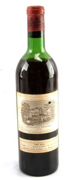 VINTAGE BOURDEAUX 1970 CHATEAU LAFITE-ROTHSCHILD: Vintage 1970 Chateau Lafite-Rothschild red Bordeaux blend. Label and seal still present. Top shoulder ullage. Cherry red color. The label has some foxing and tears, but overall good condition. Tight w
