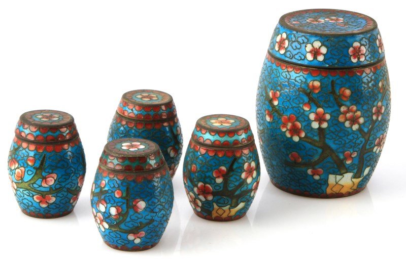 5 PIECE VINTAGE CHINESE CLOISONNE BARREL BOXES: Set of 5 lidded barrel trinket boxes with cloisonne design. Colbalt blue interior, teal background with Cherry Blossoms along the body. The largest piece measures 3.5 inches tall, the smaller boxes me