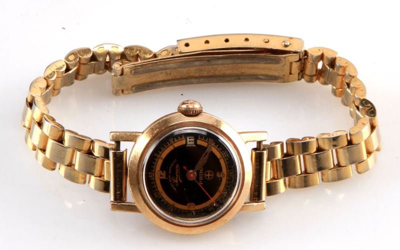 LADIES VINTAGE WEST END WATCH PRIMA WITH DATE: Vintage West End Watch Company, Prima model for ladies, gold plated case, gold filled bezel, stem wind and set, jeweled movement, date feature, black dial with gold trim (marginal), red sweep second h