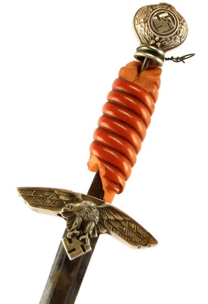 WWII THIRD REICH GERMAN 2ND MODEL LUFTWAFFE DAGGER: A second model Luftwaffe dagger with broken amber grip and missing scabbard. tip. Matching patina on pommel and crossguard, some oxidation on unmarked blade and denting to scabbard near tip. Some of t