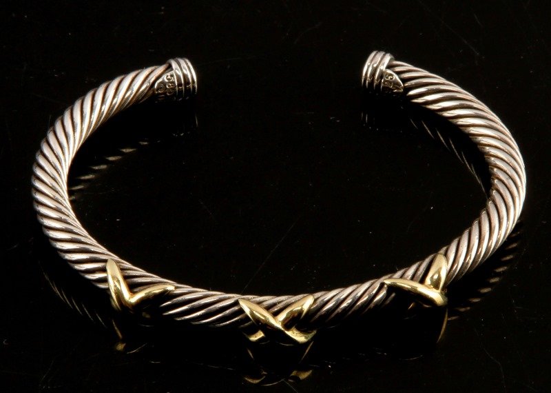 DAVID YURMAN X BRACELET STERLING AND GOLD: Original David Yurman "X Collection" sterling silver and 14 karat gold bracelet. The bracelet has a coiled cable design with three "x"s along the front. The cable is 5 mm wide. The bracelet is a small