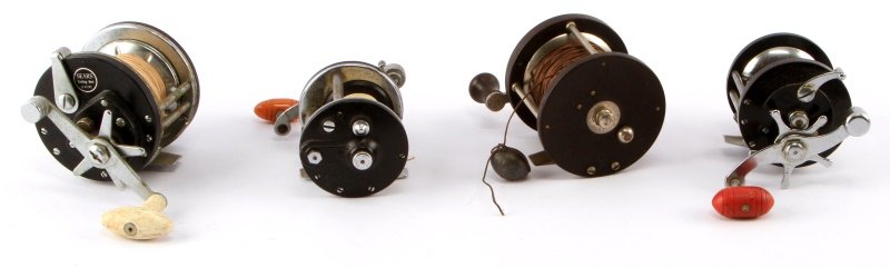 LOT OF 4 1950'S - 60'S DEEP SEA FISHING REELS: Four vintage fishing reels. Includes: Sears trolling reel 6 41242, steel pivot bearing reel 250, Penn Peerless no. 9, and a J.C. Higgins 484. Good condition.