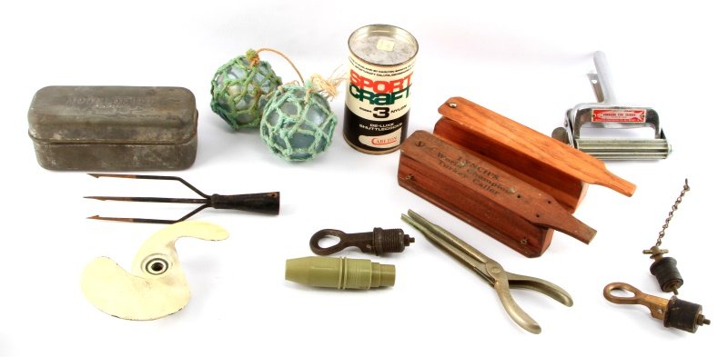 MIXED FISHING TURKEY CALL LOT PLUGS FLOATERS MORE: Mixed fishing/hunting lot. Includes: turkey calls, badminton shuttlecocks, 1965 5hp Evenrude prop, float balls, metal lure box, boat plugs, fish skinner, 6 pound head hook remover. Good vintage condit