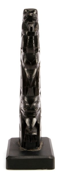 ARGILLITE HAIDA HAND CARVED 9 INCH TOTEM POLE: Description on base describes this Totem as follows "Argillite, Carved by Herman H. Collinson. Mute Haida Indian, Skidegate, B.C.. Black shale like material initially containing 8% water. Found only i