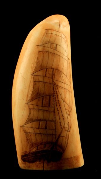 DOUBLE SIDED SCRIMSHAW BALD EAGLE CLIPPER SHIP: Pre-ban whale tooth scrimshaw depicting a clipper ship one one side and a bald eagle on the other. The piece has a few age cracks along opening. This work is unsigned. Overall good condition for its a