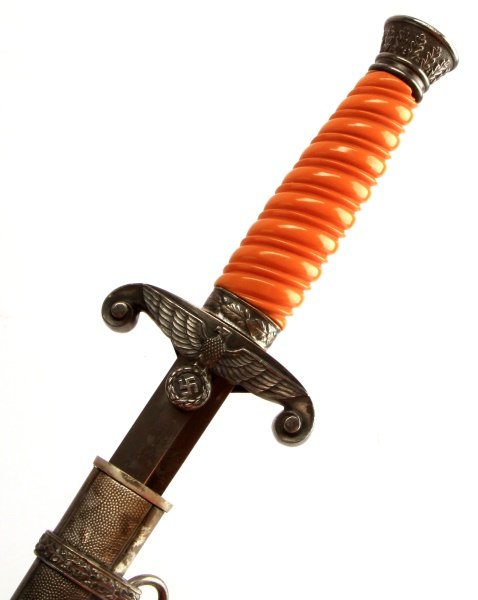 WWII THIRD REICH GERMAN HEER ARMY DAGGER UNCLEANED: An uncleaned Heer officer's dagger with F.W. Holler maker's mark. The bakelite grip is free of any wear or damage as are the pommel, ferrule and cross guard. The blade is bright and with cross grain v