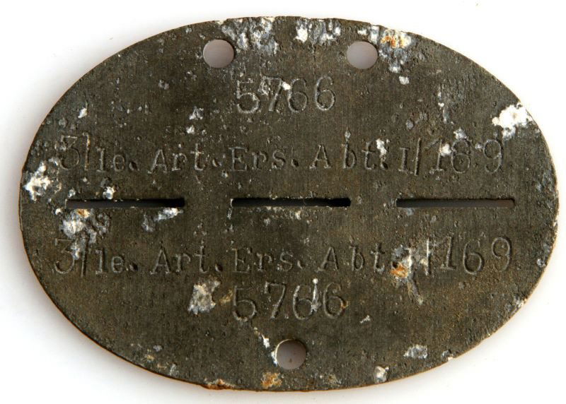WWII GERMAN DOG TAG INFANTRY WITH LEATHER POUCH: WWII German dog tag with original leather sleeve. Reads: "5766 3 le. Art. Ers. Abt. I/169". Some corrosion but overall very good condition. The leather pouch measures 3.25 inches wide by 2.75 inches t