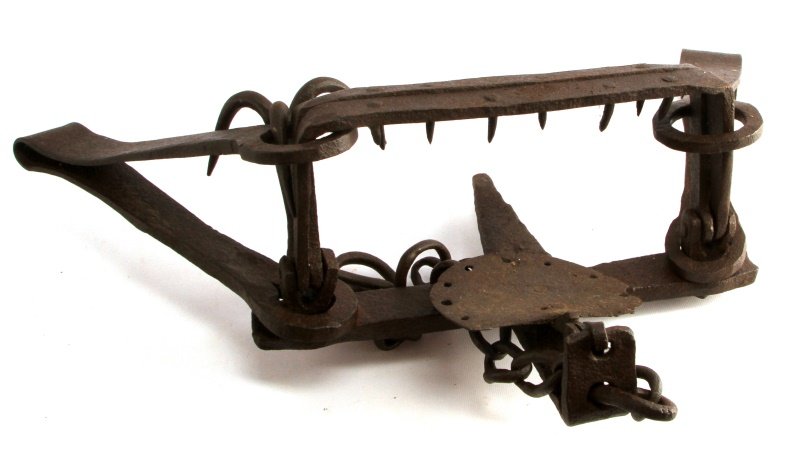 VINTAGE CAST IRON BEAR TRAP WITH CHAIN ANCHOR: Antique bear trap complete with original chain and anchor, equipped with double springs, a square jaw and nail-bent teeth. Built sometime in the early 1900s, this item is in great vintage condition an