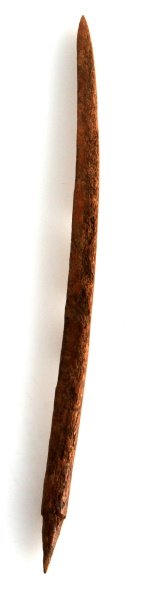 LONG NATIVE AMERICAN RIB BONE FISHING SPEAR TIP: A Native American fishing barbed fishing spear crafted out of a rib bone. Measures 9 inches long. In very good condition with no chips or damage. The dark patina on the surface of the bone suggests th