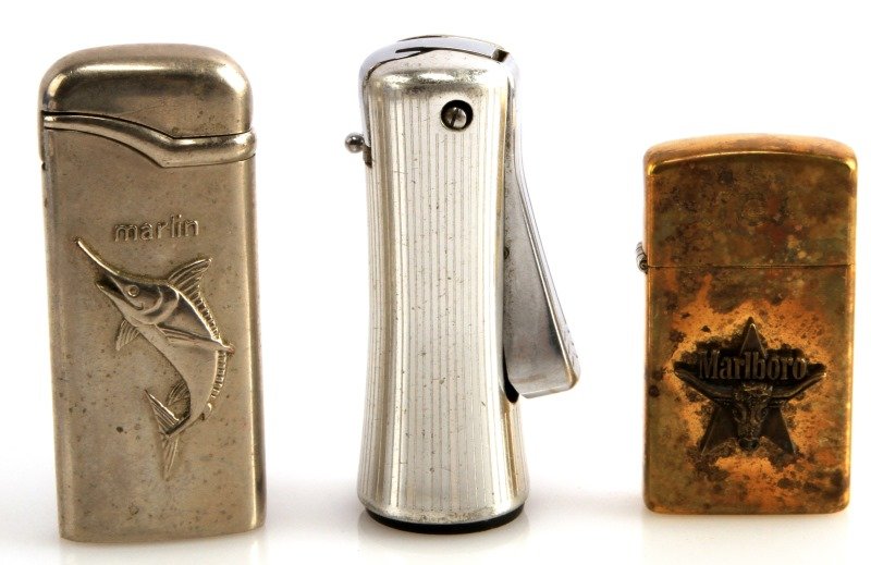 RONSON LADYLITE MARLBORO VINTAGE ZIPPO & BUTANE: Unused Zippo in box and and Ladylite lighter, WZ butane with Marlin motif, all in very good condition.
