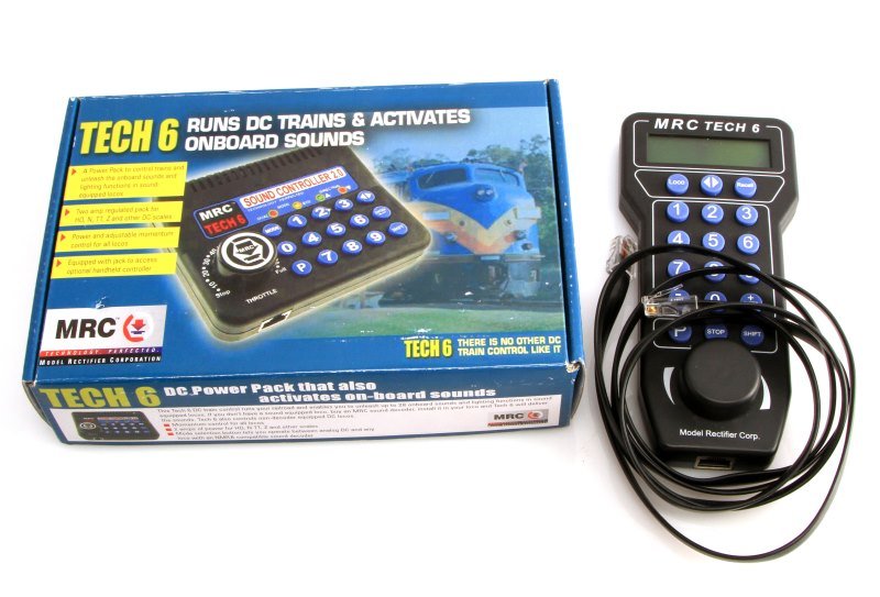 MRC TECH 6 HANDHELD LOCO & SOUND CONTROLLER 2.0: This lot contains both an MRC Tech 6 handheld locomotive controller, as well as the MRC Tech 6 sound controller 2.0. The Tech 6 sound controller acts as a DC power pack as well as a sound controller, 