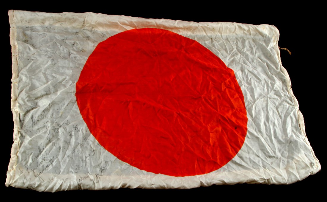 JAPANESE WWII PILOTS RED SUN SILK FLAG WITH KANJI: Japanese World War II Pilot Meat Ball Silk Flag With Kanji. Measures 29” wide by 37” long. Has a red meat ball in the center with Japanese writing on one side with padding around the border. This 